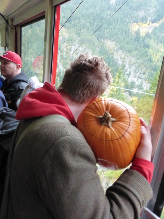 Image: H in the airtram - preparing to toss his pumpkin.